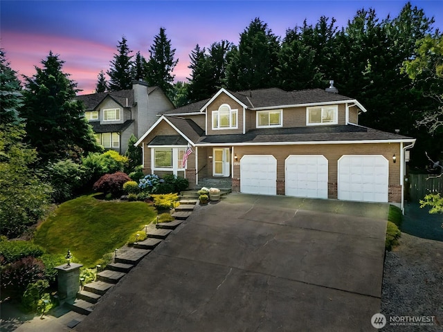 1920 11th Street Pl SW, Puyallup, WA 98371 - view of front of house with driveway, an attached garage, and brick siding