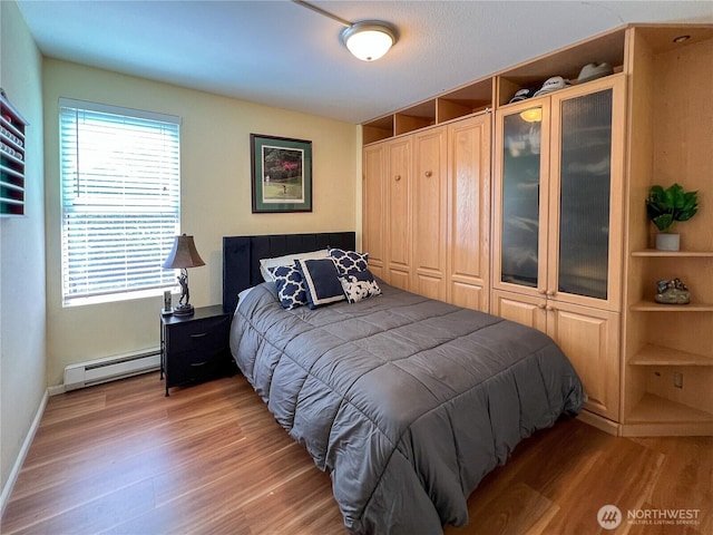 7806 Birch Bay Dr Unit 501, Blaine, WA 98230 - bedroom with a baseboard heating unit, light wood-style flooring, and a closet