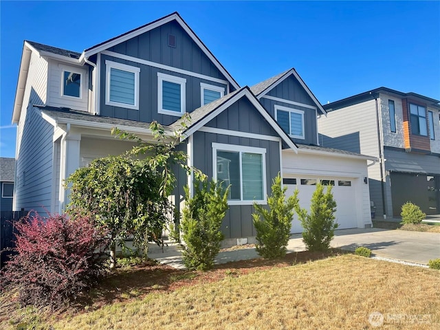 2129 Lancaster Way, Ferndale, WA 98248 - view of front facade featuring board and batten siding, an attached garage, and driveway