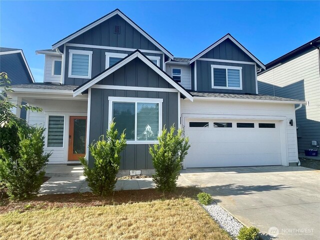 2129 Lancaster Way, Ferndale, WA 98248 - view of front facade featuring driveway, board and batten siding, and a garage