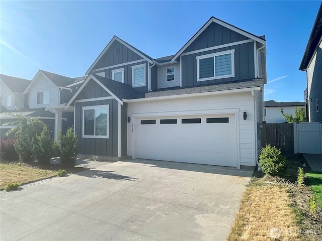 2129 Lancaster Way, Ferndale, WA 98248 - view of front of home with board and batten siding, a garage, and driveway