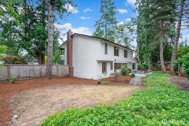 17805 NE 29th St, Redmond, WA 98052 - rear view of house featuring a chimney, a fenced backyard, and a patio