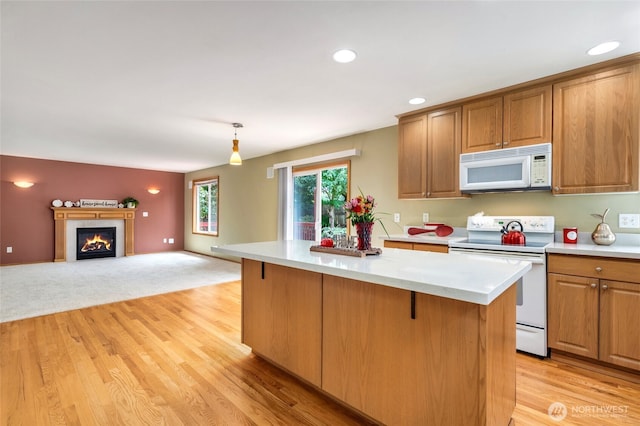 24212 13th Pl W, Bothell, WA 98021 - kitchen with white appliances, a kitchen island, light wood-style flooring, decorative light fixtures, and recessed lighting