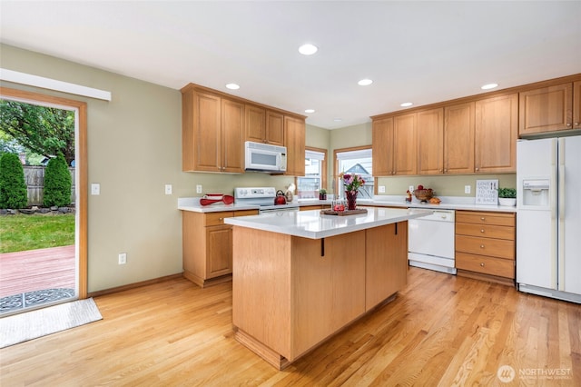 24212 13th Pl W, Bothell, WA 98021 - kitchen with white appliances, light countertops, a kitchen island, light wood-style floors, and recessed lighting