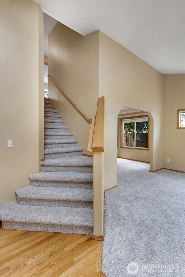 24212 13th Pl W, Bothell, WA 98021 - stairs featuring baseboards and arched walkways