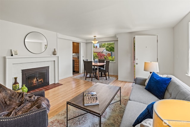 5065 SW Olga St, Seattle, WA 98116 - living room featuring wood finished floors and a fireplace