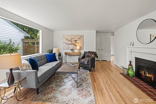 5065 SW Olga St, Seattle, WA 98116 - living area with wood finished floors and a brick fireplace