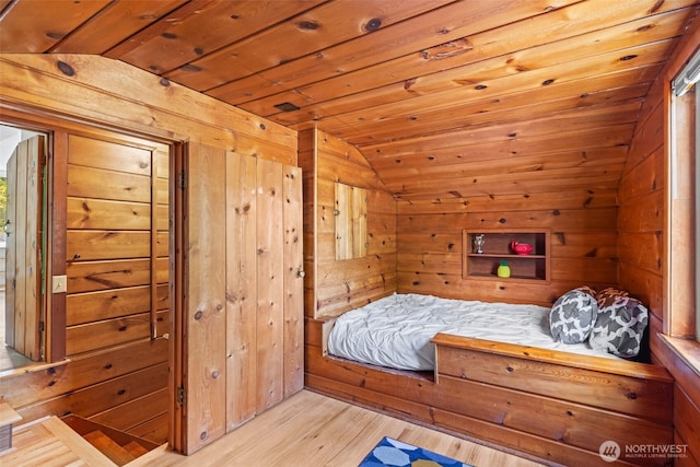 5065 SW Olga St, Seattle, WA 98116 - bedroom with vaulted ceiling, a sauna, wood finished floors, wood walls, and wooden ceiling