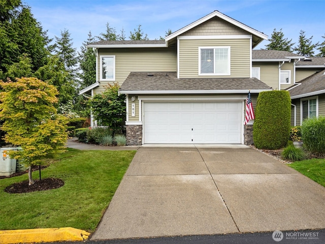 5909 Panorama Dr SE Unit 8-101, Auburn, WA 98092 - view of front of home with an attached garage, a front yard, driveway, and roof with shingles