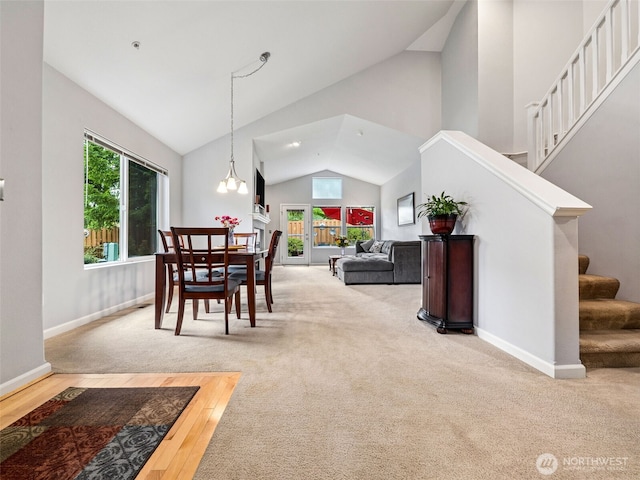 5909 Panorama Dr SE Unit 8-101, Auburn, WA 98092 - carpeted dining area featuring stairway and high vaulted ceiling