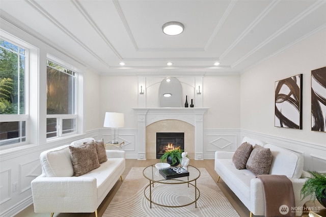 15006 Old Manor Way, Lynnwood, WA 98087 - living room with a raised ceiling, a decorative wall, a fireplace, crown molding, and light wood finished floors