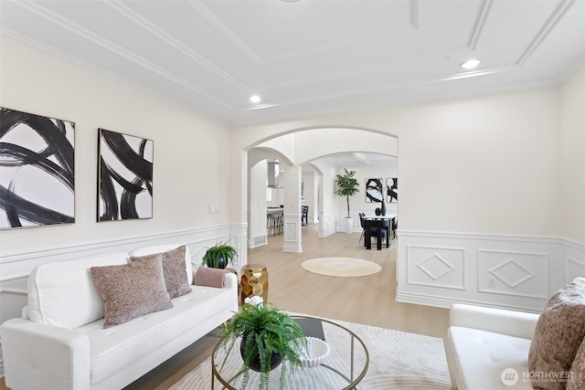 15006 Old Manor Way, Lynnwood, WA 98087 - living area with arched walkways, a tray ceiling, recessed lighting, wainscoting, and wood finished floors