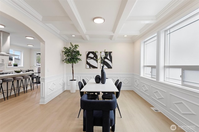 15006 Old Manor Way, Lynnwood, WA 98087 - dining room with arched walkways, light wood-style flooring, beamed ceiling, coffered ceiling, and a wainscoted wall