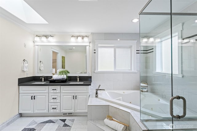 15006 Old Manor Way, Lynnwood, WA 98087 - full bathroom with double vanity, a whirlpool tub, a stall shower, a skylight, and crown molding