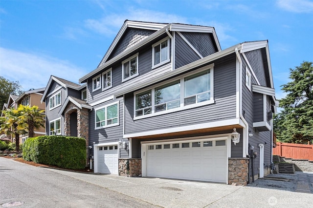 15006 Old Manor Way, Lynnwood, WA 98087 - view of front of home with an attached garage, stone siding, and concrete driveway