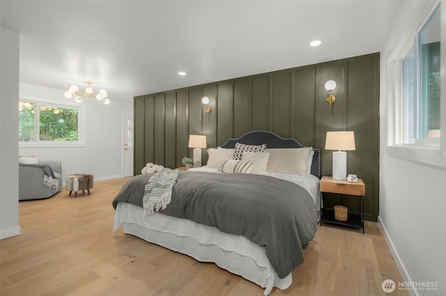 107 219th Pl SE, Bothell, WA 98021 - bedroom with a chandelier, light wood-style flooring, a decorative wall, and recessed lighting