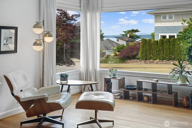 1604 28th Ave W, Seattle, WA 98199 - sitting room with plenty of natural light, wood finished floors, and a water view