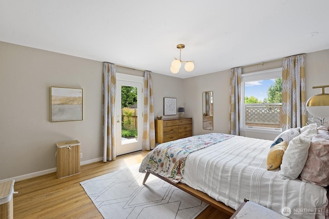 1604 28th Ave W, Seattle, WA 98199 - bedroom with multiple windows, access to outside, and light wood-style floors