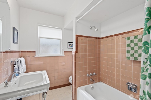 1604 28th Ave W, Seattle, WA 98199 - full bath featuring shower / bath combo with shower curtain, tile patterned floors, tile walls, and wainscoting