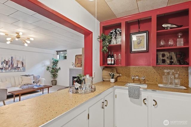 1604 28th Ave W, Seattle, WA 98199 - kitchen featuring open shelves, a brick fireplace, light countertops, decorative backsplash, and white cabinets