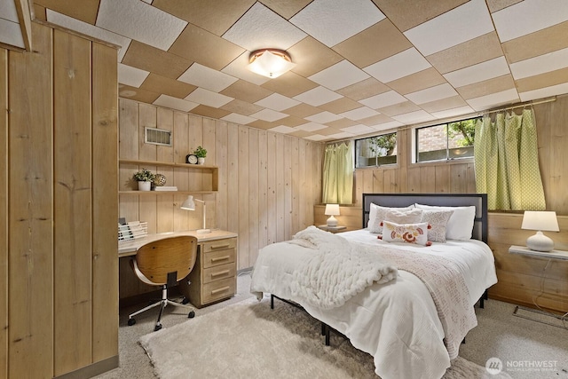 1604 28th Ave W, Seattle, WA 98199 - bedroom featuring wooden walls, an office area, and light carpet