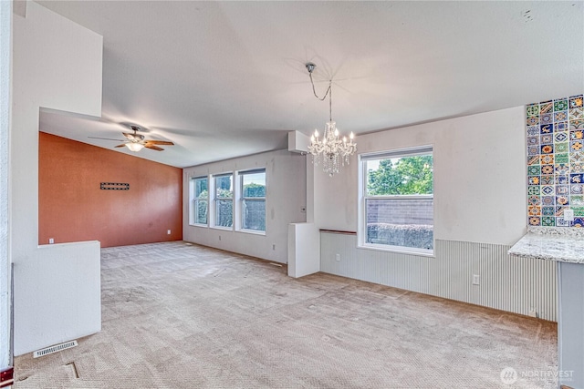 530 Sunday Dr, East Wenatchee, WA 98802 - spare room with a chandelier, plenty of natural light, carpet flooring, a ceiling fan, and a wainscoted wall