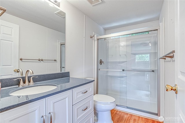 530 Sunday Dr, East Wenatchee, WA 98802 - bathroom with a shower stall, vanity, wood finished floors, and a textured ceiling