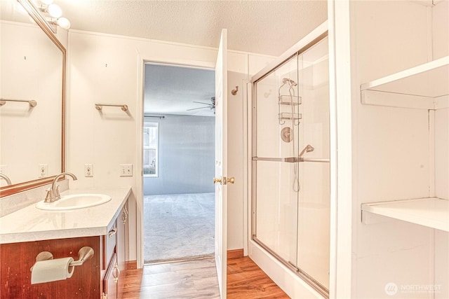530 Sunday Dr, East Wenatchee, WA 98802 - bathroom featuring vanity, a shower stall, wood finished floors, and a textured ceiling