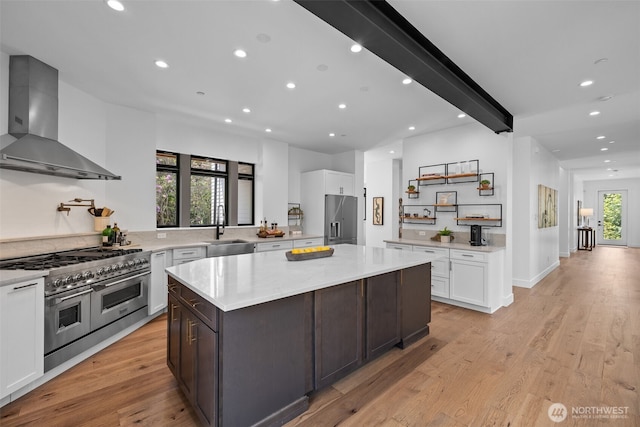 2115 Squak Mountain Loop SW, Issaquah, WA 98027 - kitchen with wall chimney range hood, appliances with stainless steel finishes, white cabinetry, recessed lighting, and a center island