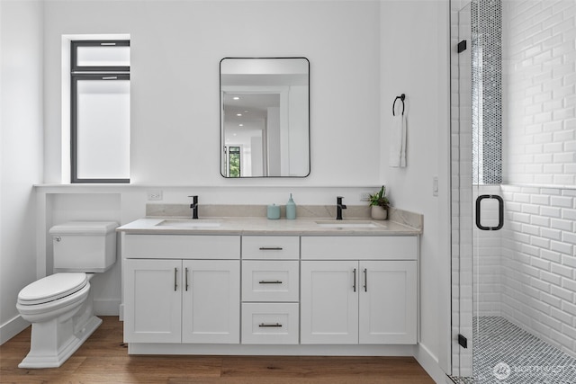 2115 Squak Mountain Loop SW, Issaquah, WA 98027 - bathroom with double vanity, a stall shower, and wood finished floors