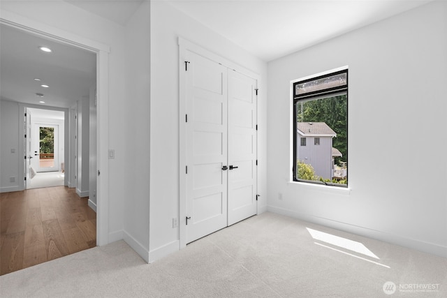 2115 Squak Mountain Loop SW, Issaquah, WA 98027 - unfurnished bedroom with multiple windows, recessed lighting, a closet, and carpet flooring