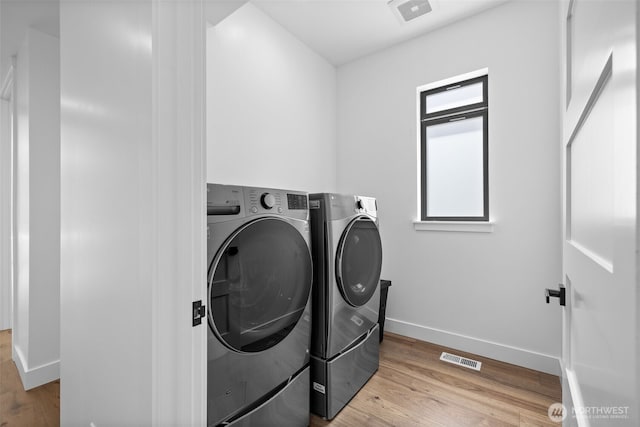 2115 Squak Mountain Loop SW, Issaquah, WA 98027 - washroom with washing machine and clothes dryer and wood finished floors