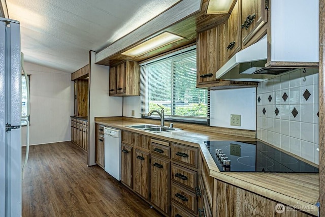 12614 113th Ave E Unit 247, Puyallup, WA 98374 - kitchen with white dishwasher, black electric cooktop, brown cabinets, dark wood-style flooring, and vaulted ceiling