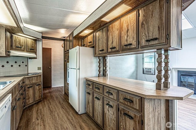 12614 113th Ave E Unit 247, Puyallup, WA 98374 - kitchen featuring white appliances, under cabinet range hood, dark wood-type flooring, and tasteful backsplash