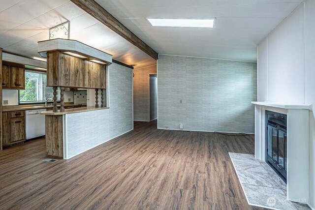 12614 113th Ave E Unit 247, Puyallup, WA 98374 - kitchen featuring dishwasher, a glass covered fireplace, dark wood-type flooring, brown cabinetry, and light countertops