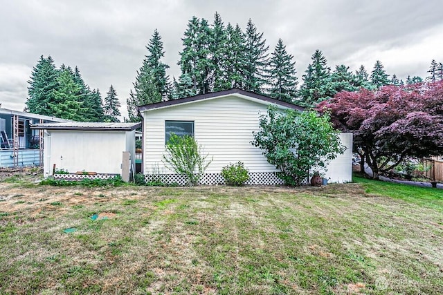12614 113th Ave E Unit 247, Puyallup, WA 98374 - view of home's exterior featuring a lawn
