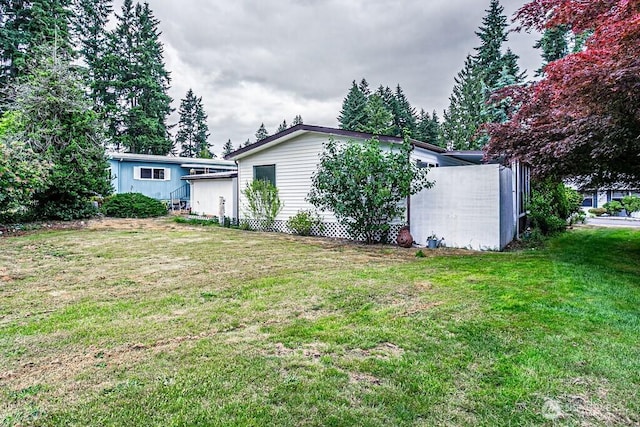 12614 113th Ave E Unit 247, Puyallup, WA 98374 - rear view of property featuring a yard