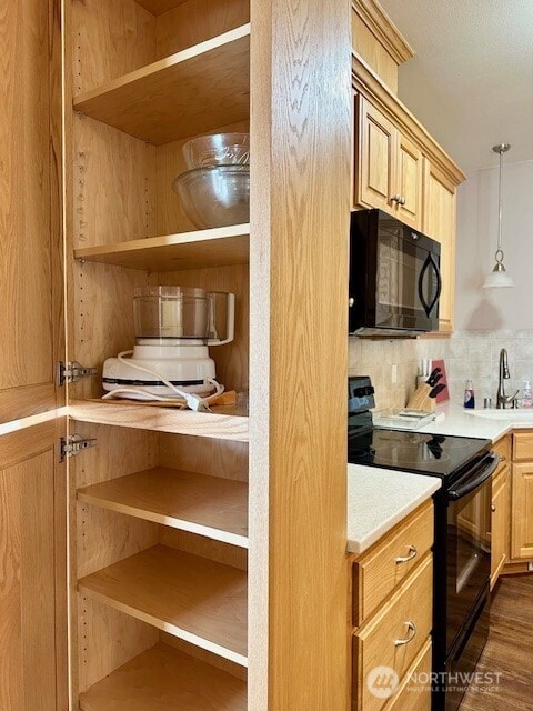 1548 River Rd Unit 105, Longview, WA 98632 - kitchen with black appliances, open shelves, backsplash, light countertops, and pendant lighting
