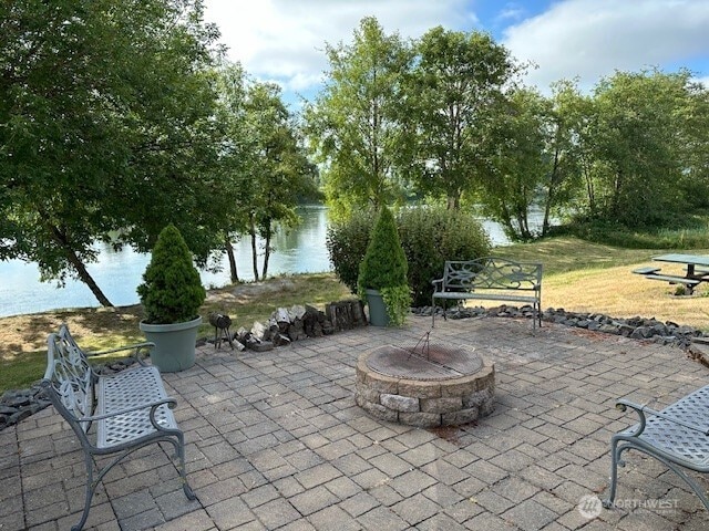 1548 River Rd Unit 105, Longview, WA 98632 - view of patio with a water view and a fire pit