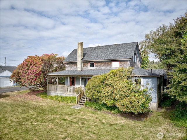 209 3rd St SE, Long Beach, WA 98631 - back of property featuring covered porch, a yard, a chimney, and a shingled roof