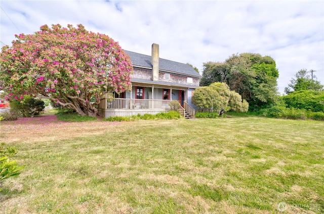 209 3rd St SE, Long Beach, WA 98631 - back of house with covered porch, a yard, and a chimney