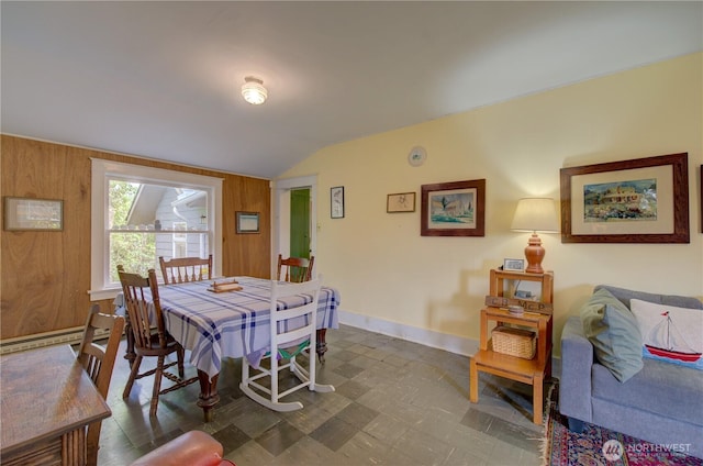 209 3rd St SE, Long Beach, WA 98631 - dining space with lofted ceiling, a baseboard radiator, and wood walls