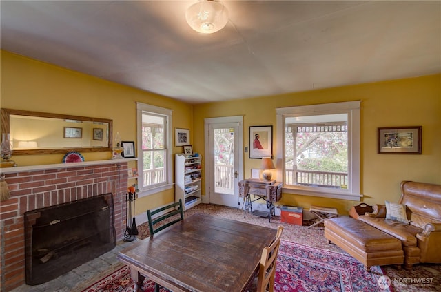 209 3rd St SE, Long Beach, WA 98631 - living room featuring healthy amount of natural light and a brick fireplace