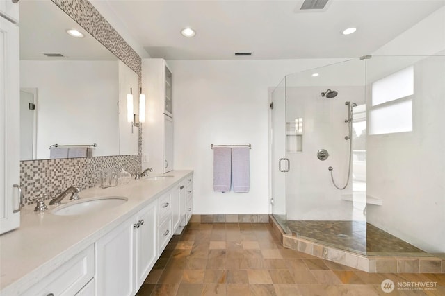 1634 Palm Ave SW, Seattle, WA 98116 - bathroom featuring a stall shower, double vanity, tasteful backsplash, and recessed lighting