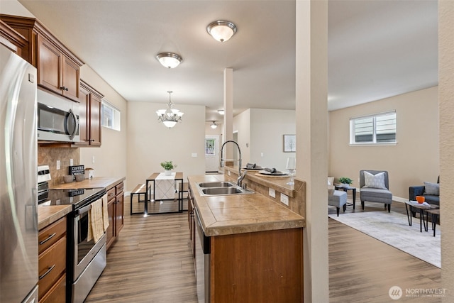 4444 Edgewater Blvd NE, Lacey, WA 98516 - kitchen with appliances with stainless steel finishes, wood finished floors, decorative backsplash, and plenty of natural light