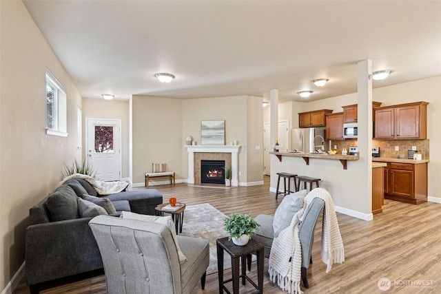 4444 Edgewater Blvd NE, Lacey, WA 98516 - living area with light wood finished floors and a tiled fireplace
