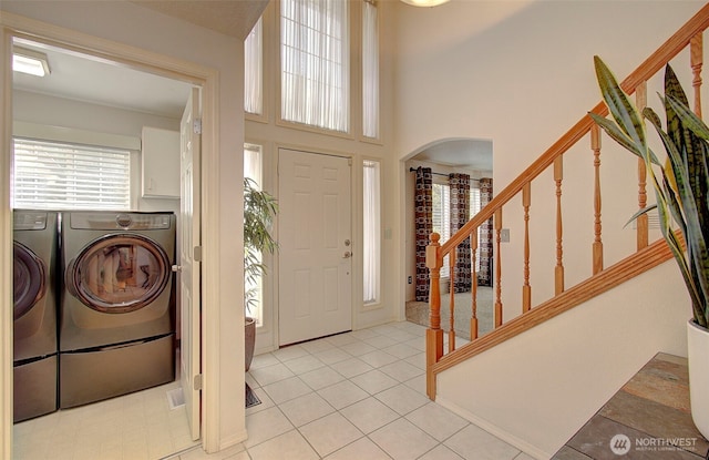 15108 NE 22nd Ave, Salmon Creek, WA 98686 - foyer with washer and clothes dryer, stairs, arched walkways, and light tile patterned floors