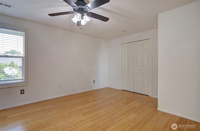 15108 NE 22nd Ave, Salmon Creek, WA 98686 - unfurnished bedroom with light wood-style floors, multiple windows, a textured ceiling, a closet, and a ceiling fan