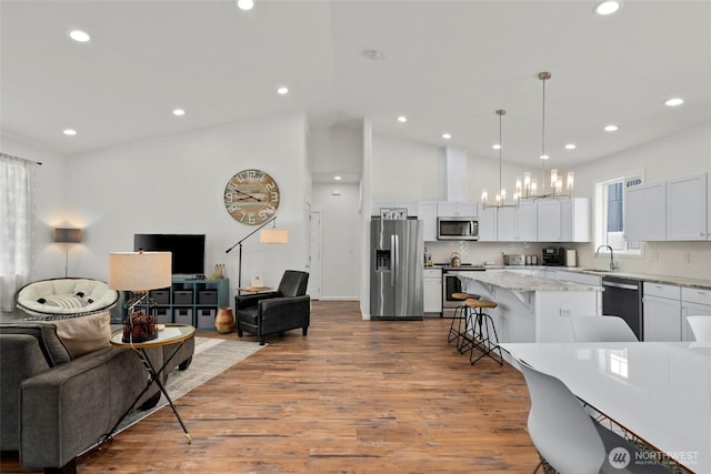1828 Kristina Ln, Wenatchee, WA 98801 - kitchen featuring appliances with stainless steel finishes, open floor plan, a kitchen breakfast bar, a center island, and recessed lighting