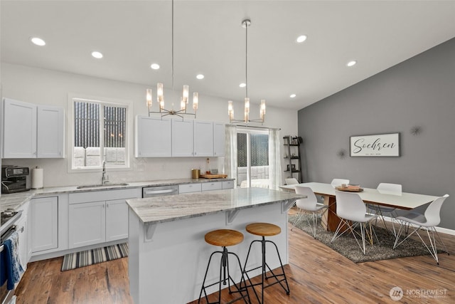 1828 Kristina Ln, Wenatchee, WA 98801 - kitchen with plenty of natural light, dark wood-style flooring, a breakfast bar area, white cabinets, and recessed lighting